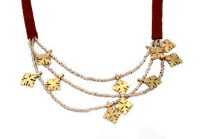 Handcrafted triple-strand necklace with mixed metal amulets and brown leather strap.