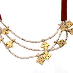 Handcrafted triple-strand necklace with mixed metal amulets and brown leather strap.