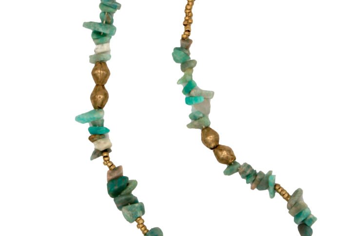 Handcrafted turquoise bead necklace with gold accents and amulet charm.