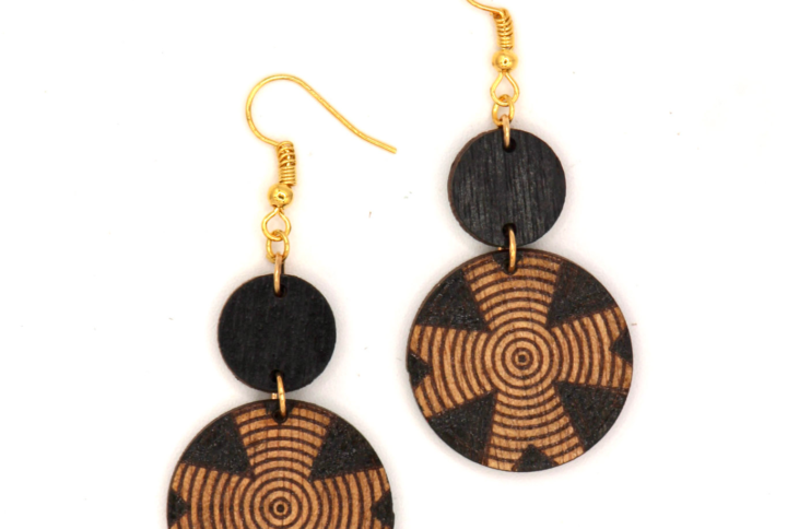 Hand-carved wooden earrings inspired by traditional Ethiopian woven baskets, featuring circular designs and intricate engraved patterns.