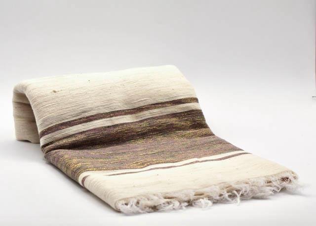 Handwoven cotton scarf in warm brown and cream tones, crafted in Ethiopia and Eritrea.